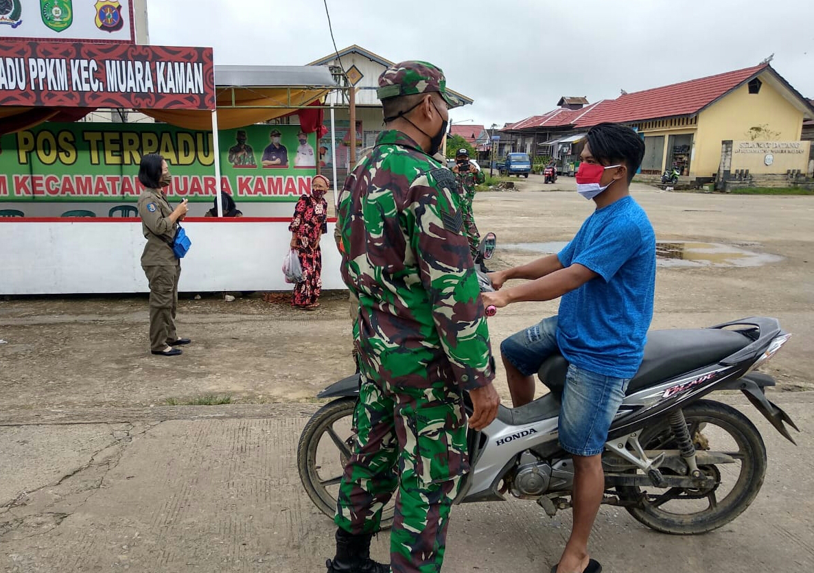 Jaring Pelanggar Prokes, Babinsa Muara Kaman Berikan Masker